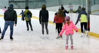 People skating on an indoor arena ice surface