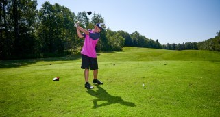 Child swinging golf club on the golf course