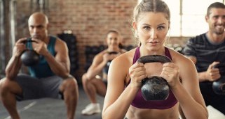 Group of people exercising with kettlebells