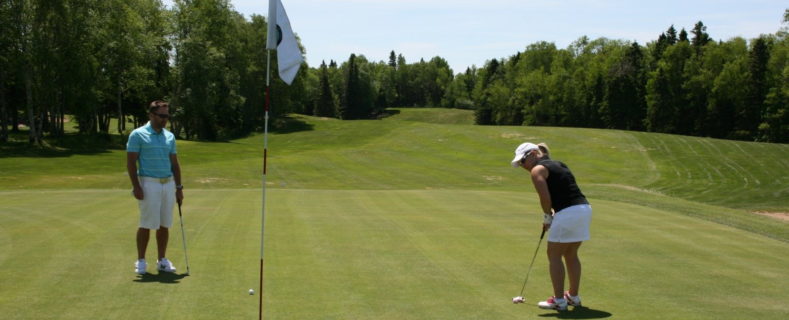 man and woman playing golf