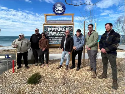 Mayor, Council, Chief Duncan, and delegates at the pebble beach sign